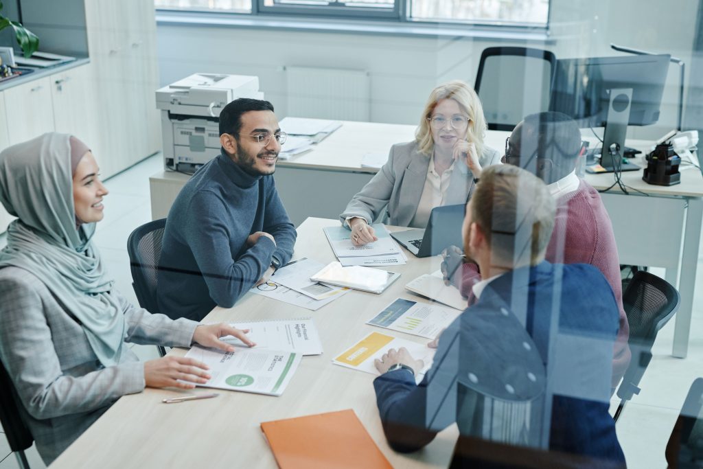 small meeting Small business team reviewing an AI acceptable use policy together.